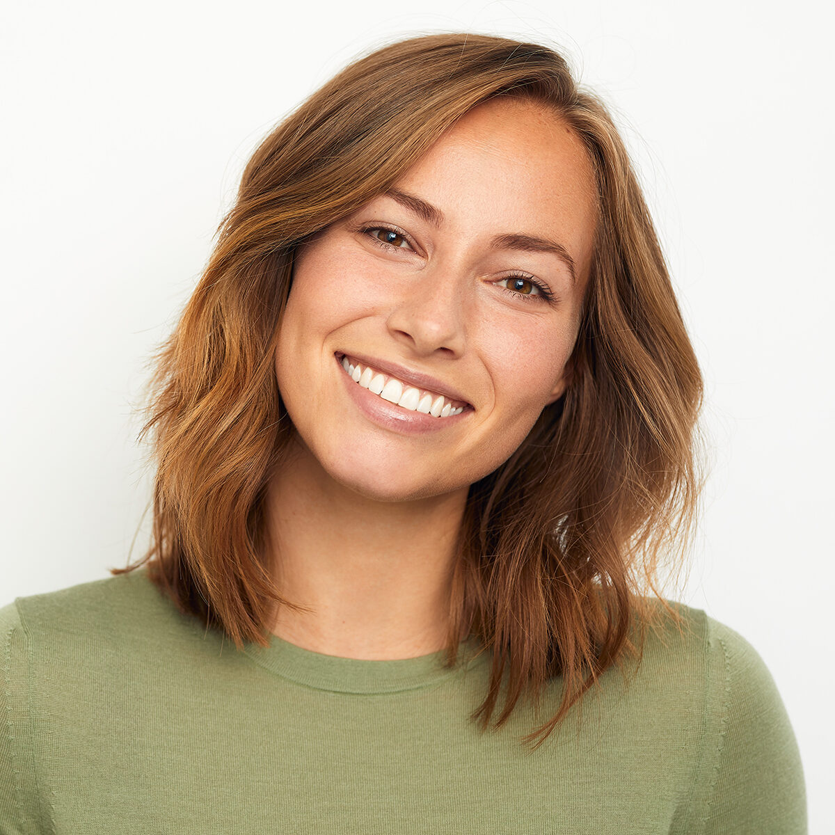 portrait of a young happy woman smiling on white background